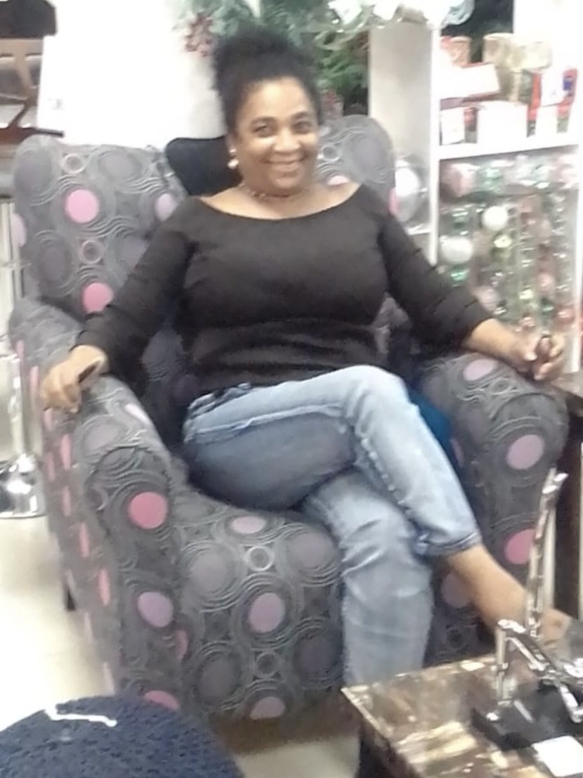 Julette Joy Prayogg smiling in an armchair